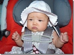 Madeline tries on some hats for us