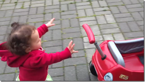 Madeline pushes the red car